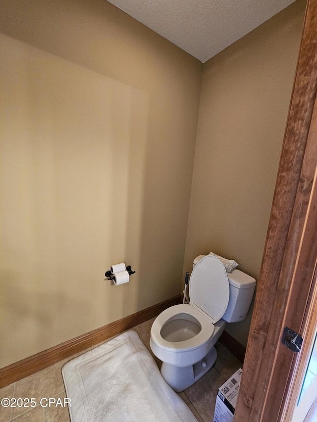 bathroom featuring a textured ceiling and toilet