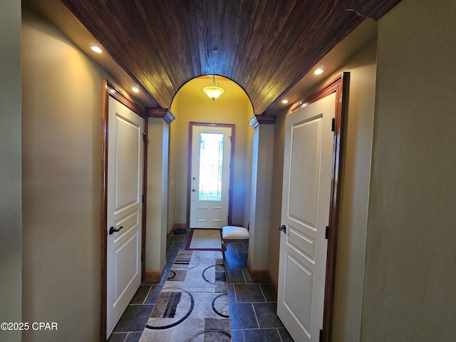 doorway with lofted ceiling and wooden ceiling