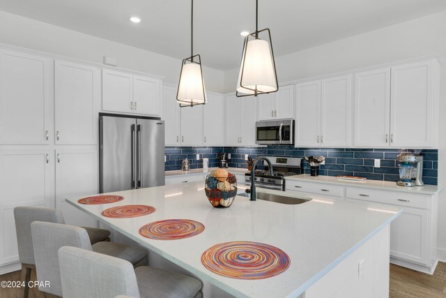 13639 Banana Wind Way, Panama City Beach, FL 32413 - kitchen featuring stainless steel appliances, a sink, light countertops, white cabinets, and recessed lighting