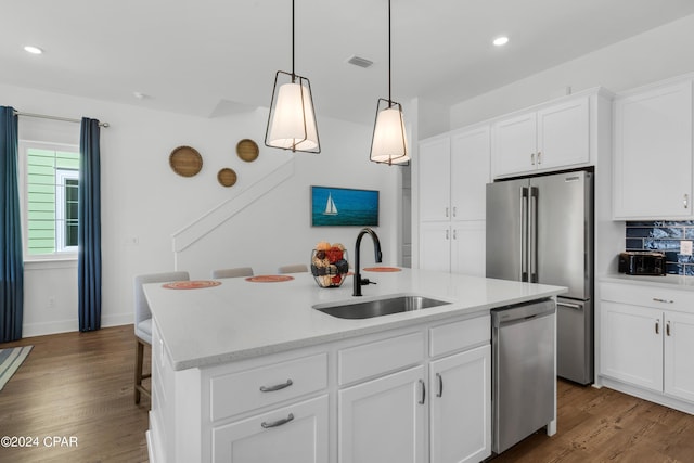 13639 Banana Wind Way, Panama City Beach, FL 32413 - kitchen with appliances with stainless steel finishes, a sink, recessed lighting, dark wood-style flooring, and an island with sink