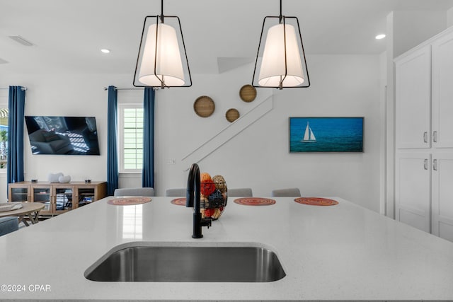 13639 Banana Wind Way, Panama City Beach, FL 32413 - kitchen featuring a sink, hanging light fixtures, white cabinetry, recessed lighting, and light stone counters