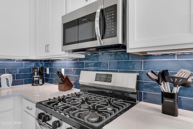 13639 Banana Wind Way, Panama City Beach, FL 32413 - kitchen with appliances with stainless steel finishes, white cabinets, and light stone countertops