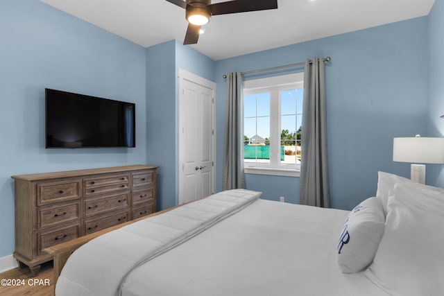 13639 Banana Wind Way, Panama City Beach, FL 32413 - bedroom featuring wood finished floors, baseboards, ceiling fan, and a closet