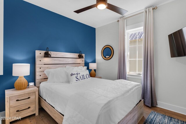 13639 Banana Wind Way, Panama City Beach, FL 32413 - bedroom with baseboards, wood finished floors, and ceiling fan