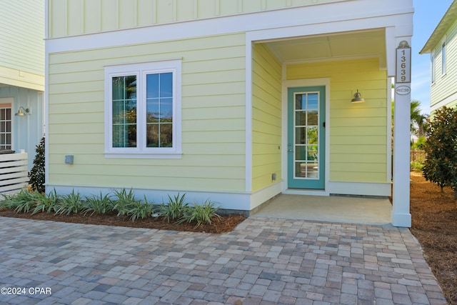 13639 Banana Wind Way, Panama City Beach, FL 32413 - view of exterior entry with board and batten siding