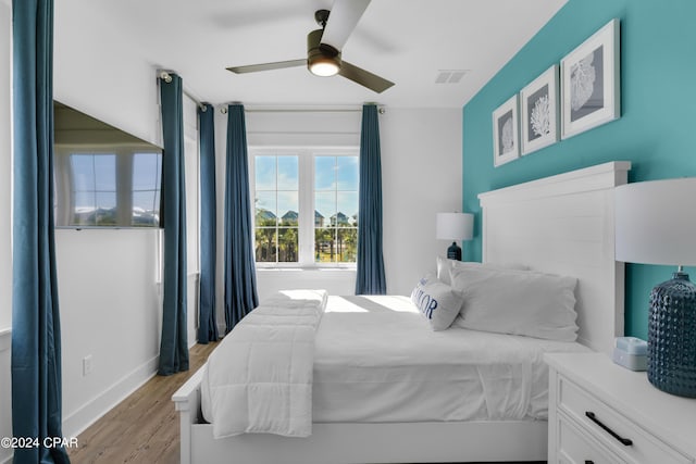 13639 Banana Wind Way, Panama City Beach, FL 32413 - bedroom with light wood-type flooring, baseboards, and ceiling fan