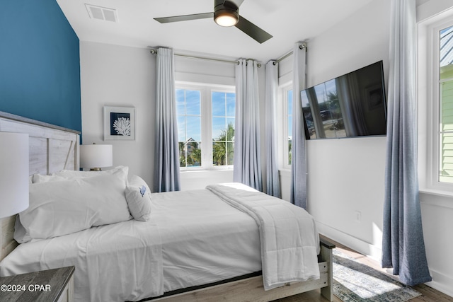 13639 Banana Wind Way, Panama City Beach, FL 32413 - bedroom with multiple windows, wood finished floors, and ceiling fan