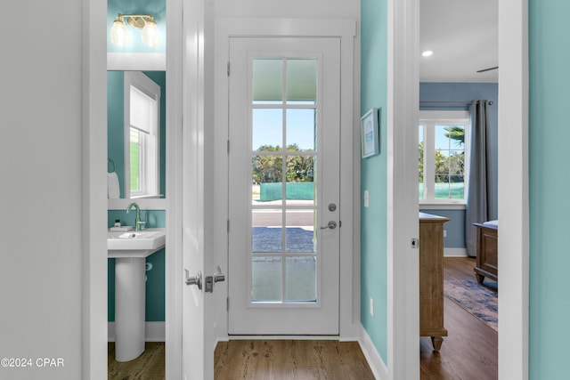 13639 Banana Wind Way, Panama City Beach, FL 32413 - doorway with baseboards, wood finished floors, and a sink