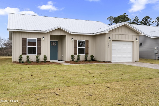 view of front of home with a garage, driveway, a front lawn, and metal roof