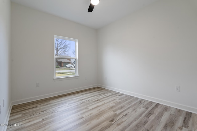 empty room featuring light wood-style floors, ceiling fan, and baseboards