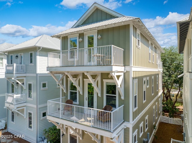 back of house featuring a balcony