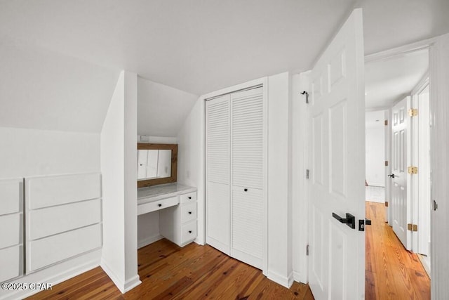 interior space featuring lofted ceiling and wood finished floors