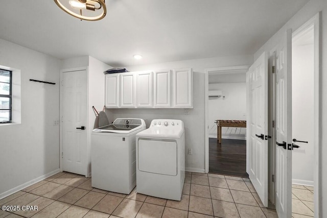 laundry room with independent washer and dryer, light tile patterned flooring, cabinet space, and baseboards