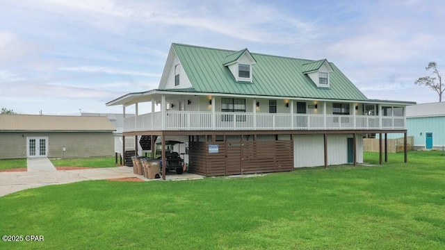 view of front of house featuring metal roof, french doors, and a front lawn