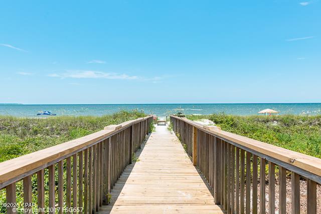 surrounding community with a view of the beach and a water view