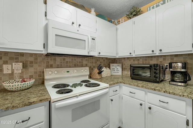 kitchen with white appliances, a toaster, white cabinetry, and tasteful backsplash