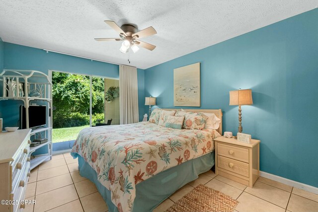 tiled bedroom with a textured ceiling, access to outside, a ceiling fan, and baseboards