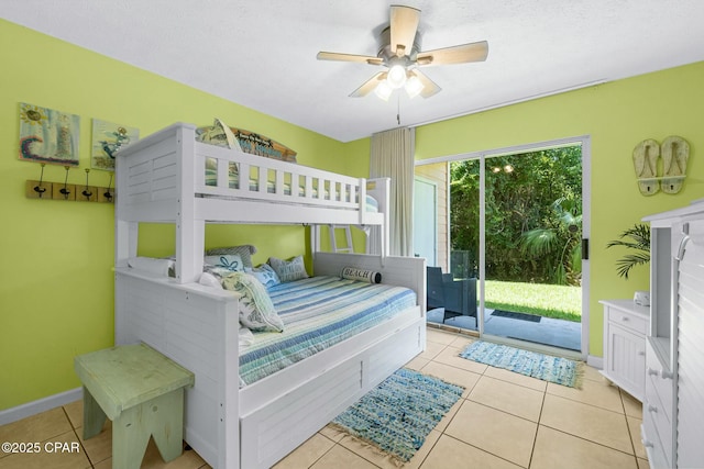 bedroom featuring access to exterior, baseboards, a ceiling fan, and tile patterned floors