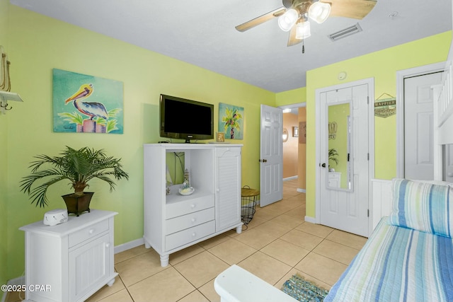 bedroom with light tile patterned floors, baseboards, visible vents, and a ceiling fan