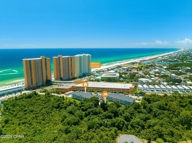 drone / aerial view featuring a beach view and a water view