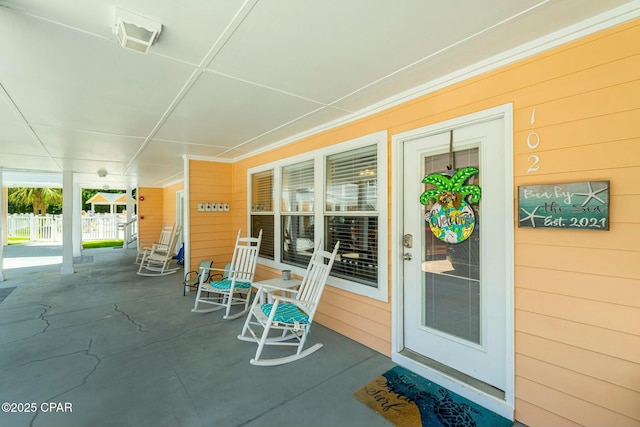 view of patio / terrace with covered porch, fence, and visible vents