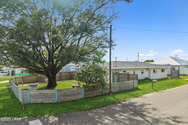 ranch-style home with fence private yard and a front lawn