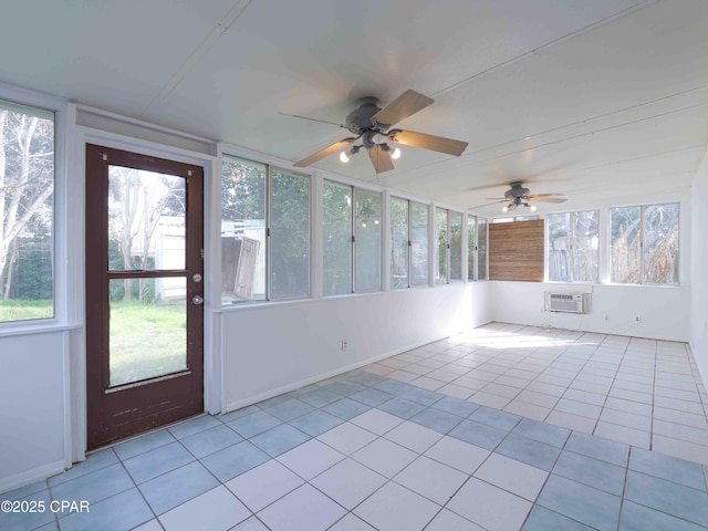 unfurnished sunroom featuring a wall unit AC and a healthy amount of sunlight