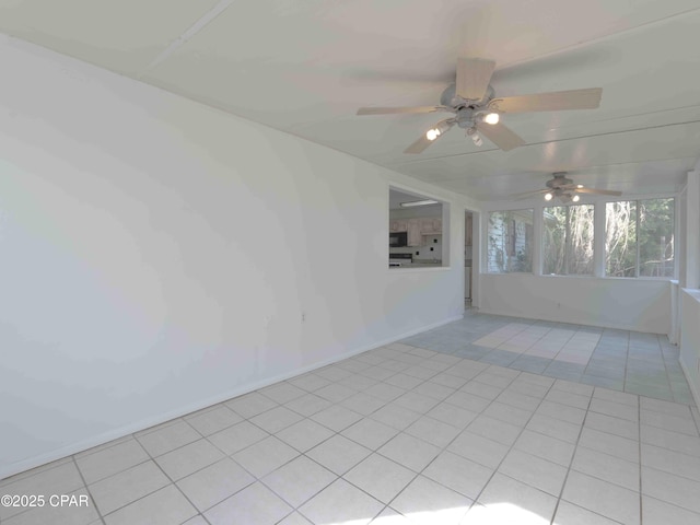 empty room featuring light tile patterned floors and a sunroom