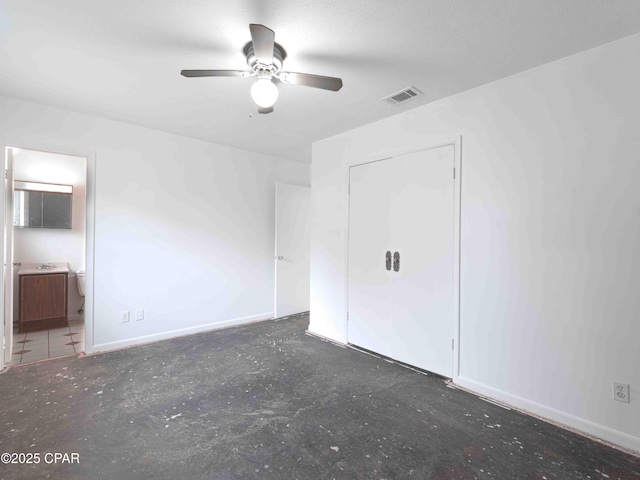 unfurnished bedroom featuring a ceiling fan, visible vents, baseboards, and ensuite bathroom