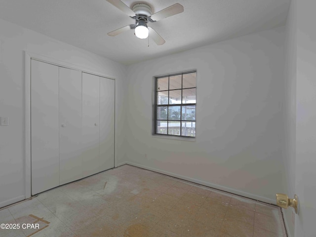 unfurnished bedroom featuring light floors, a closet, and a ceiling fan