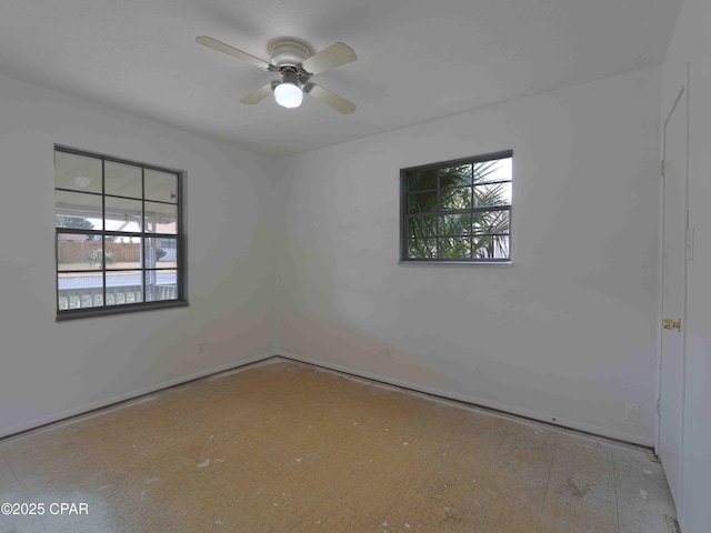 unfurnished room featuring plenty of natural light and ceiling fan