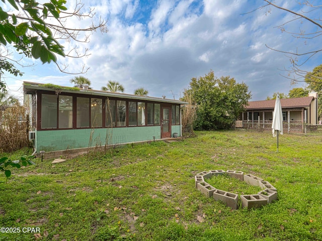 view of yard with a sunroom and fence