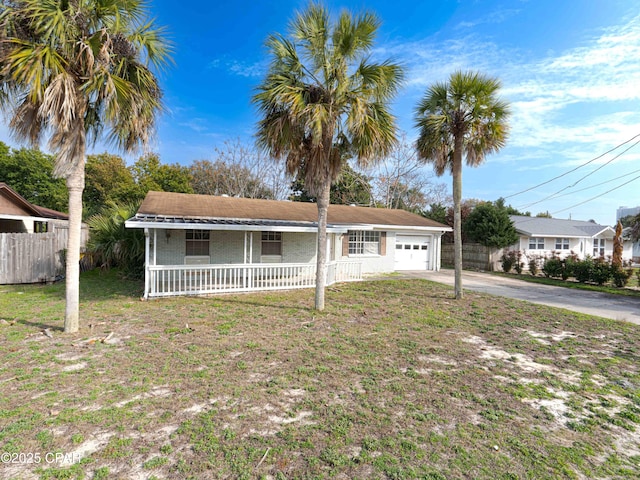 single story home featuring a garage, concrete driveway, fence, and a front lawn