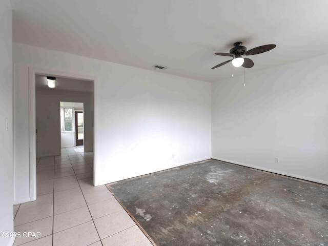 empty room with a ceiling fan, visible vents, and light tile patterned floors