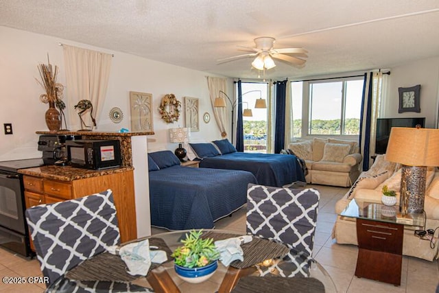 8817 Thomas Dr Unit A618, Panama City Beach, FL 32408 - living room with light tile patterned floors, a ceiling fan, and expansive windows