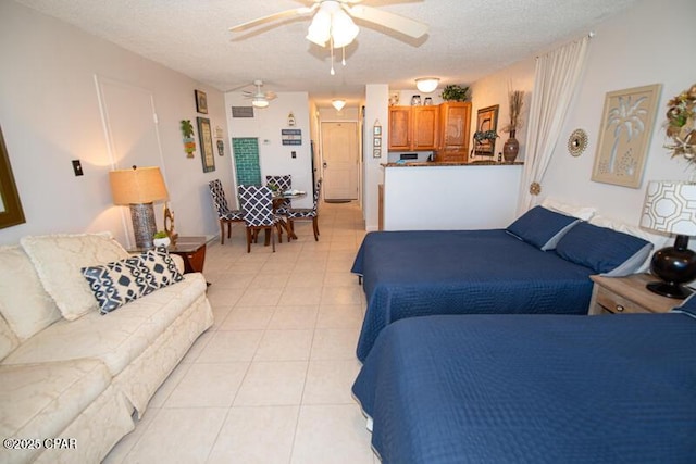 8817 Thomas Dr Unit A618, Panama City Beach, FL 32408 - bedroom featuring light tile patterned floors, a textured ceiling, and a ceiling fan