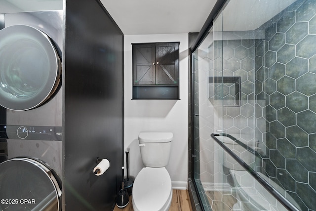 4725 Bay Point Rd Unit 258, Panama City, FL 32408 - bathroom with toilet, stacked washer / drying machine, and a shower with shower door