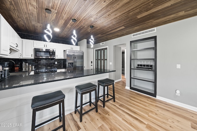 4725 Bay Point Rd Unit 258, Panama City, FL 32408 - kitchen with wood ceiling, white cabinetry, hanging light fixtures, stainless steel appliances, and light wood-type flooring