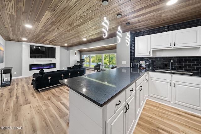 4725 Bay Point Rd Unit 258, Panama City, FL 32408 - kitchen featuring sink, light hardwood / wood-style floors, white cabinets, wooden ceiling, and kitchen peninsula