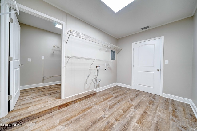 washroom featuring laundry area, washer hookup, wood finished floors, and baseboards