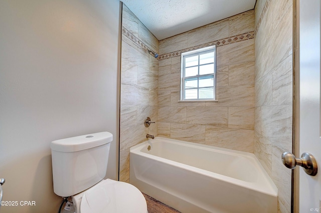 bathroom featuring shower / bathtub combination and toilet