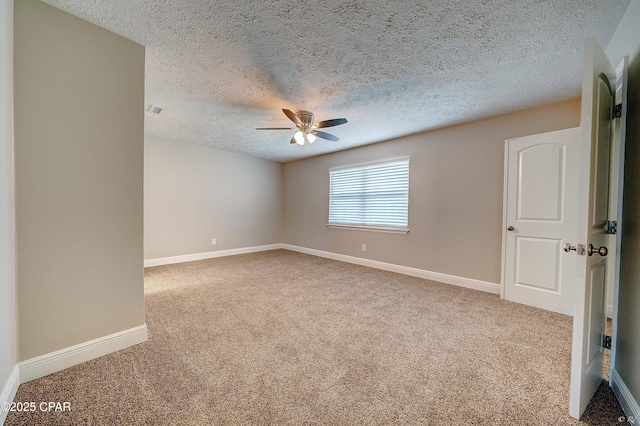 empty room featuring carpet floors, a textured ceiling, baseboards, and a ceiling fan