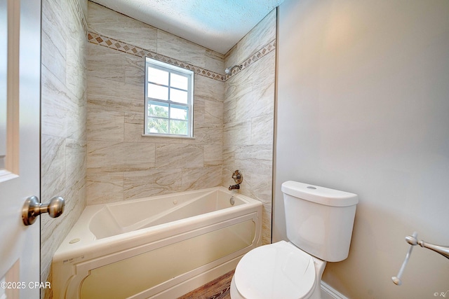 bathroom featuring tub / shower combination and toilet