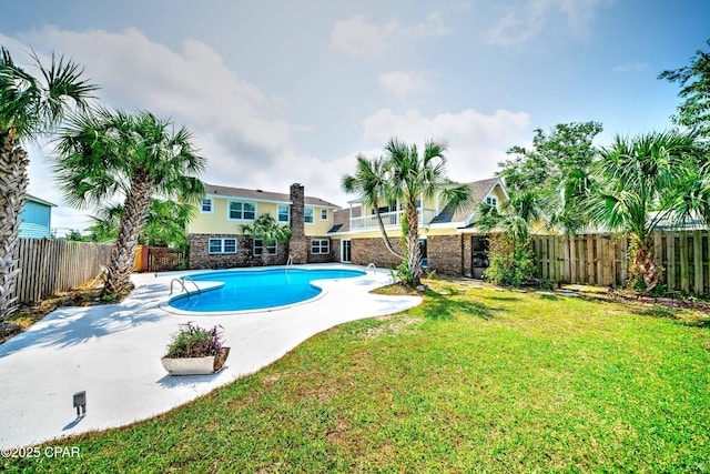 view of swimming pool featuring a yard, a patio area, a fenced backyard, and a fenced in pool