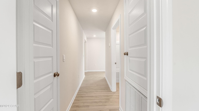 hallway with recessed lighting, baseboards, and light wood finished floors