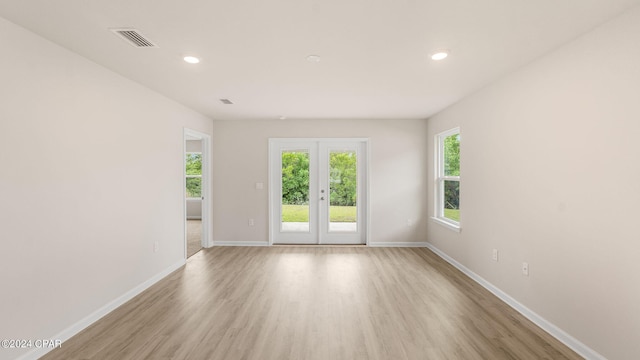 spare room with recessed lighting, light wood-type flooring, and baseboards