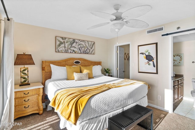 bedroom with visible vents, a barn door, a ceiling fan, carpet flooring, and baseboards