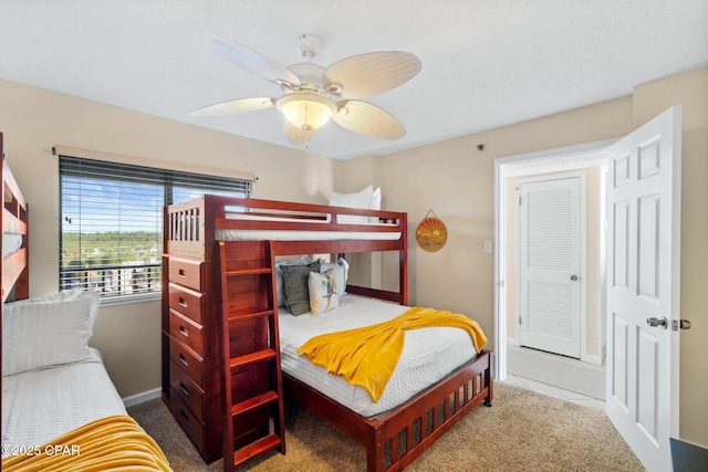 carpeted bedroom featuring ceiling fan and baseboards