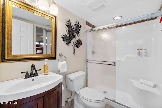 full bathroom featuring a stall shower, visible vents, vanity, and toilet