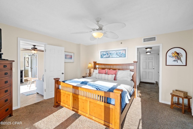 bedroom featuring a ceiling fan, baseboards, visible vents, and carpet flooring